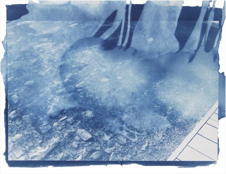 Wasseroberfläche mit sanften Wellen und Lichtreflexionen in blauen Tönen.