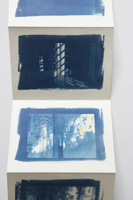 Drei blaue Drucke von Fenstern mit Wolken und Lichtspielen.