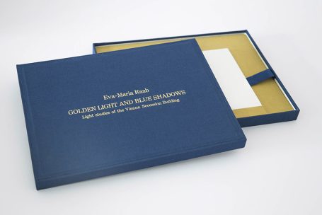 Blauer, eleganter Karton mit goldenem Text, offen und leer.